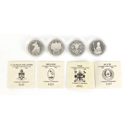 551 - Four silver proof anniversary crowns with certificates of authenticity including Cayman Islands and ... 