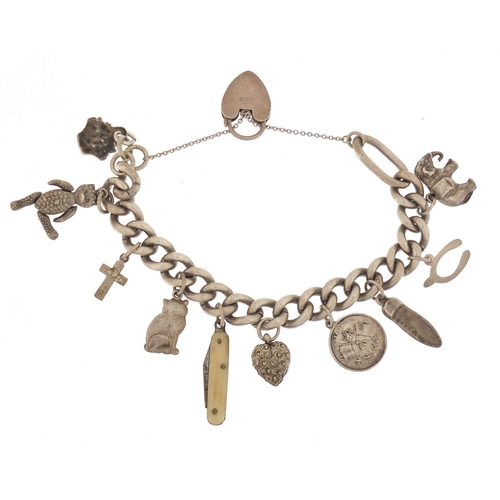 483 - Silver charm bracelet with a selection of mostly silver charms including elephant and articulated te... 