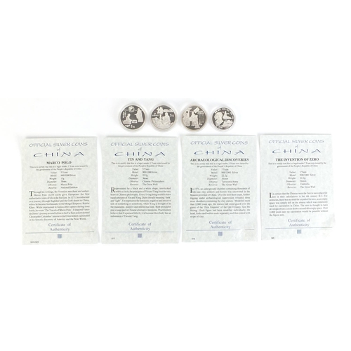 376 - Four Chinese silver five yuan with certificates of authenticity including Yin and Yang and Marco Pol... 