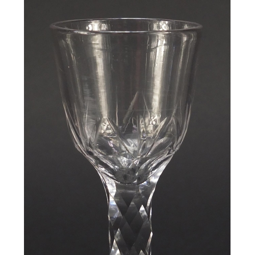 560 - 18th century wine glass with ogee bowl and faceted stem, 15cm high