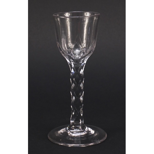 560 - 18th century wine glass with ogee bowl and faceted stem, 15cm high