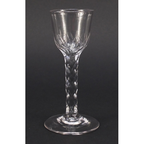 560 - 18th century wine glass with ogee bowl and faceted stem, 15cm high