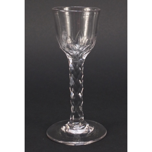 560 - 18th century wine glass with ogee bowl and faceted stem, 15cm high