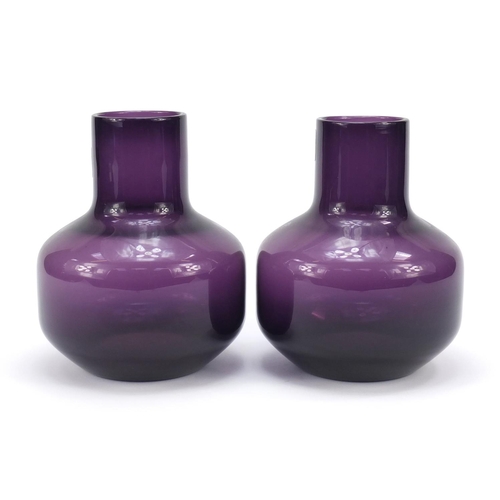 195 - Pair of Whitefriars mallet shaped amethyst glass vases with paper labels, each 17cm high