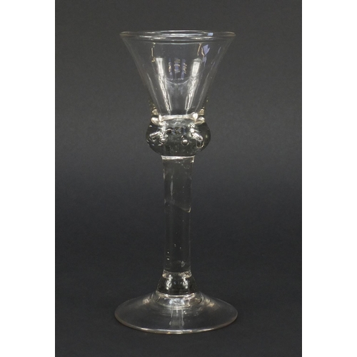 455 - 18th century baluster wine glass with trumpet bowl, shoulder knop enclosing tears and basal plain fo... 