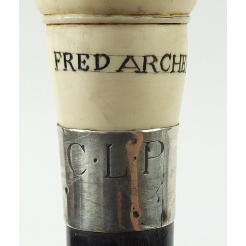 105 - Good ebonised walking stick with carved ivory pommel in the form of jockey Fred Archer, having a sil... 