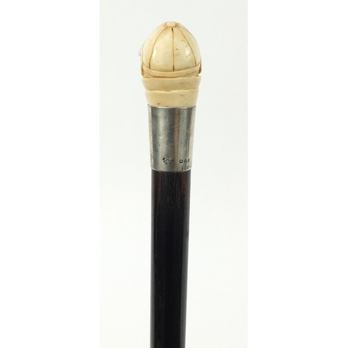 36 - Good ebonised walking stick with carved ivory pommel in the form of a monkey's head wearing a jockey... 