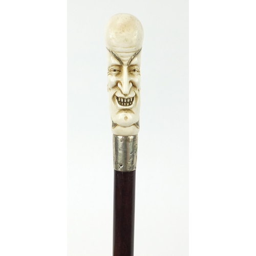 172 - Good snakewood walking stick with carved ivory pommel in the form of a man and ivory ferrule, 94cm i... 