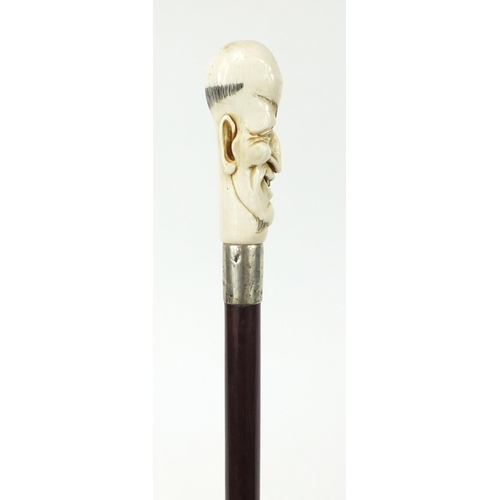 172 - Good snakewood walking stick with carved ivory pommel in the form of a man and ivory ferrule, 94cm i... 