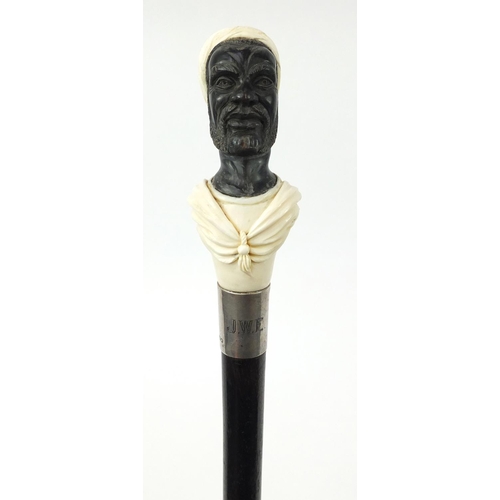 35 - Good ebonised walking stick with carved ivory and horn pommel in the form of a blackamoor, having a ... 