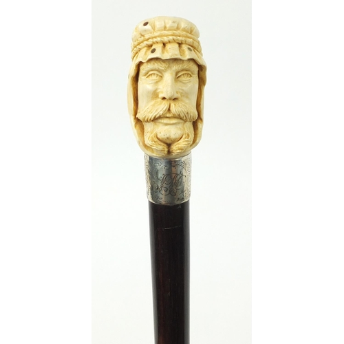 106 - Good rosewood walking stick with carved ivory and Piqué work pommel in the form of an Arab, having a... 