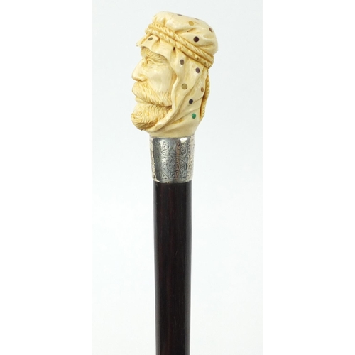 106 - Good rosewood walking stick with carved ivory and Piqué work pommel in the form of an Arab, having a... 