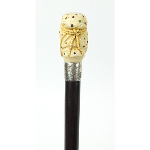 106 - Good rosewood walking stick with carved ivory and Piqué work pommel in the form of an Arab, having a... 