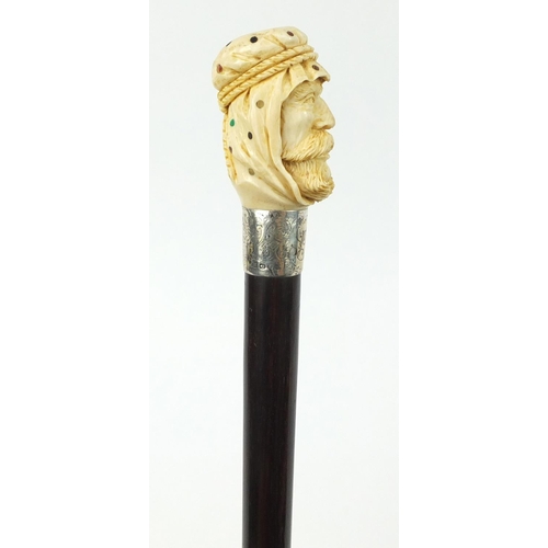 106 - Good rosewood walking stick with carved ivory and Piqué work pommel in the form of an Arab, having a... 