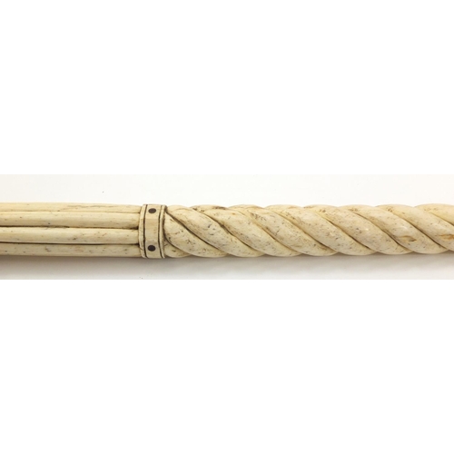 33 - Antique Scrimshaw carved whalebone walking stick with four pillars, 92.5cm in length