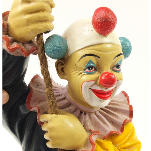 1452 - Novelty hand painted model of a clown climbing rope, 63cm high