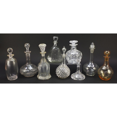 752 - Nine antique and later glass decanters including a miniature ship decanter, the largest 28.5cm high