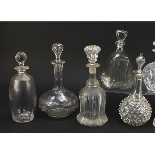 752 - Nine antique and later glass decanters including a miniature ship decanter, the largest 28.5cm high