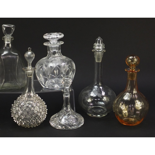 752 - Nine antique and later glass decanters including a miniature ship decanter, the largest 28.5cm high