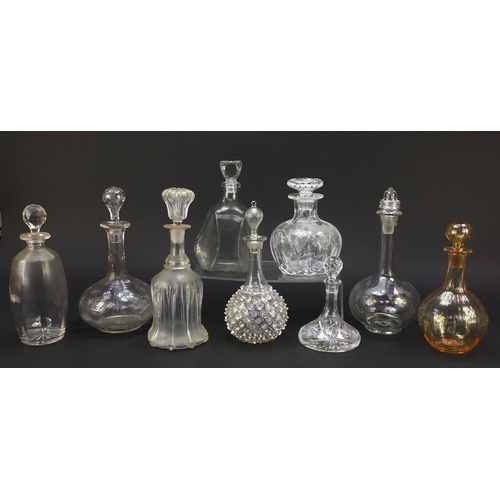 752 - Nine antique and later glass decanters including a miniature ship decanter, the largest 28.5cm high