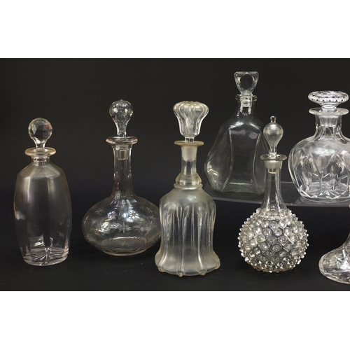 752 - Nine antique and later glass decanters including a miniature ship decanter, the largest 28.5cm high