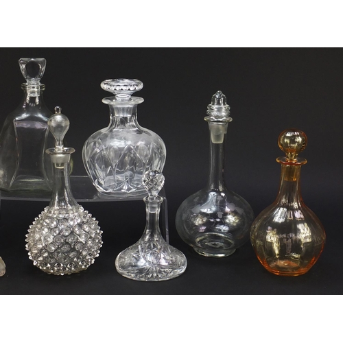 752 - Nine antique and later glass decanters including a miniature ship decanter, the largest 28.5cm high