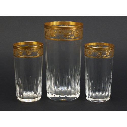 846 - Three Baccarat crystal glasses with gilt floral borders, the largest 15cm high