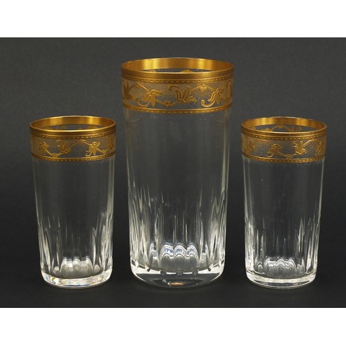 846 - Three Baccarat crystal glasses with gilt floral borders, the largest 15cm high