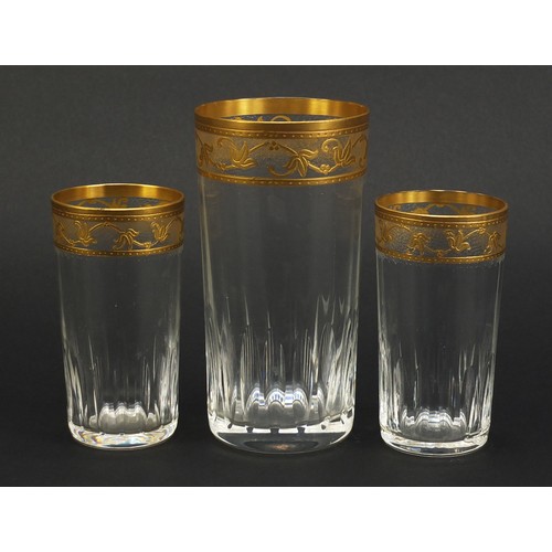 846 - Three Baccarat crystal glasses with gilt floral borders, the largest 15cm high