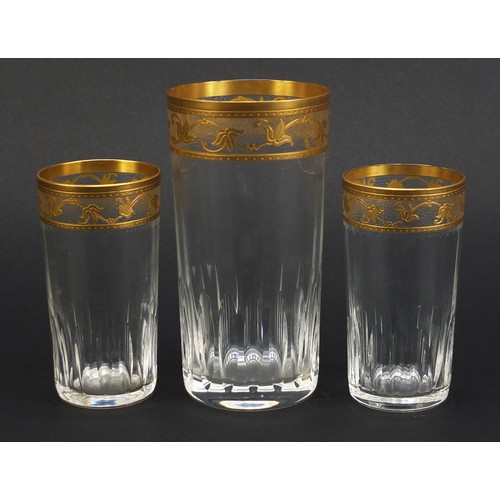 846 - Three Baccarat crystal glasses with gilt floral borders, the largest 15cm high