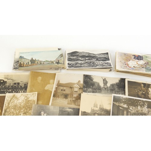 1313 - Edwardian and later postcards, some black and white photographic including street scenes, military s... 