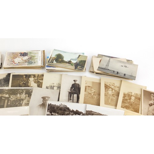 1313 - Edwardian and later postcards, some black and white photographic including street scenes, military s... 