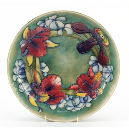 139 - William Moorcroft pottery shallow bowl hand painted in the Orchid pattern onto a green ground, 27cm ... 