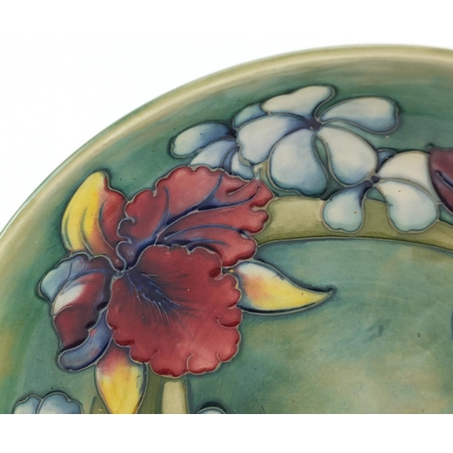 139 - William Moorcroft pottery shallow bowl hand painted in the Orchid pattern onto a green ground, 27cm ... 