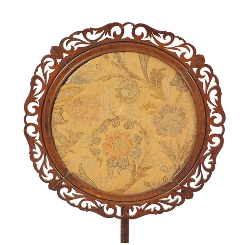 242 - Victorian rosewood pole screen with paw feet housing circular tapestry panel of flowers, 136cm high