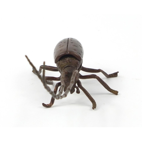 500 - Japanese patinated bronze locust with articulated antennae, wings and legs, 12cm in length