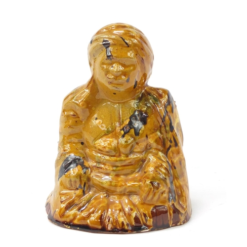 472 - Turkish Canakkale pottery figure of a man having a yellow and brown glaze, 15.5cm high