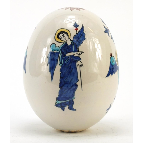 473 - Turkish Armenian Kutahya pottery suspension egg hand painted with winged figures and masks, 18.5cm h... 