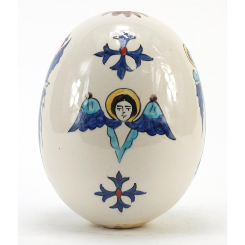 473 - Turkish Armenian Kutahya pottery suspension egg hand painted with winged figures and masks, 18.5cm h... 