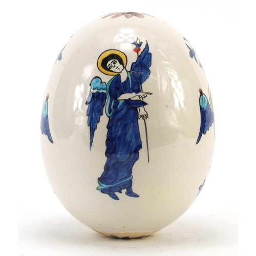 473 - Turkish Armenian Kutahya pottery suspension egg hand painted with winged figures and masks, 18.5cm h... 