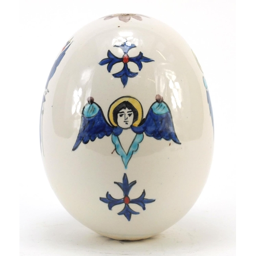 473 - Turkish Armenian Kutahya pottery suspension egg hand painted with winged figures and masks, 18.5cm h... 