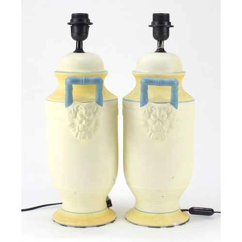 950 - Pair of classical style painted porcelain table lamps with grotesque twin handles, each 47cm high