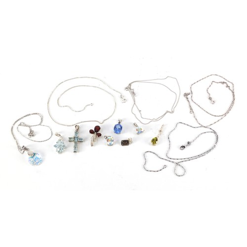 1128 - Silver pendants set with colourful stones, some with chains, 27.1g