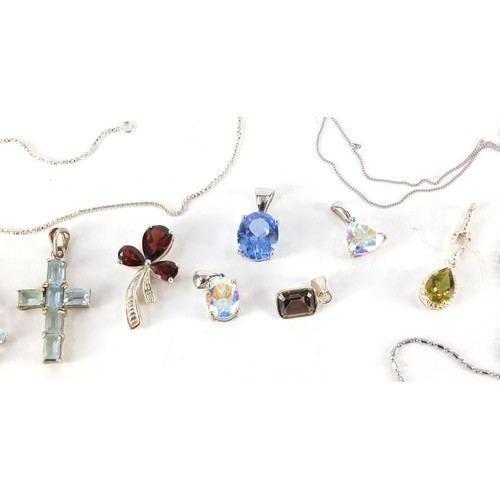 1128 - Silver pendants set with colourful stones, some with chains, 27.1g