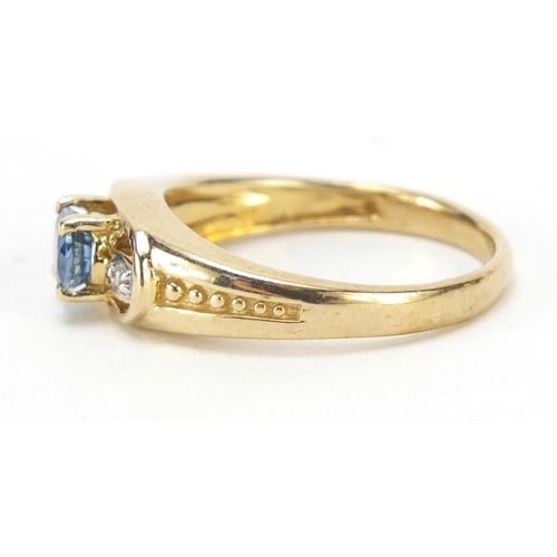 1187 - 9ct gold blue topaz and diamond three stone ring, size N, 3.0g