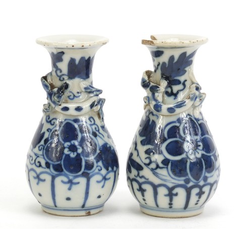 1139 - Pair of Chinese blue and white porcelain vases with relief dragons, each hand painted with flowers, ... 