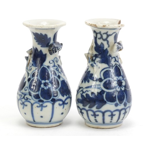 1139 - Pair of Chinese blue and white porcelain vases with relief dragons, each hand painted with flowers, ... 