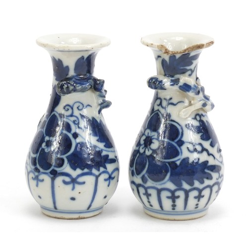 1139 - Pair of Chinese blue and white porcelain vases with relief dragons, each hand painted with flowers, ... 