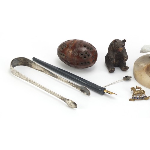 1257 - Objects including a tooled leather notepad, Georgian silver sugar tongs and a carved coquilla nut