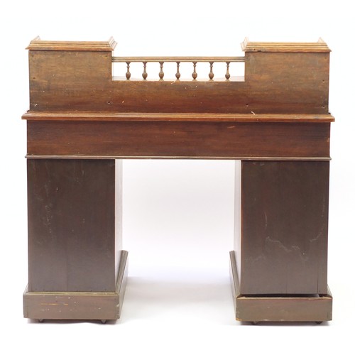 1633 - Oak twin pedestal desk with tooled leather insert and a series of drawers, 100cm H x 106cm W x 63cm ... 